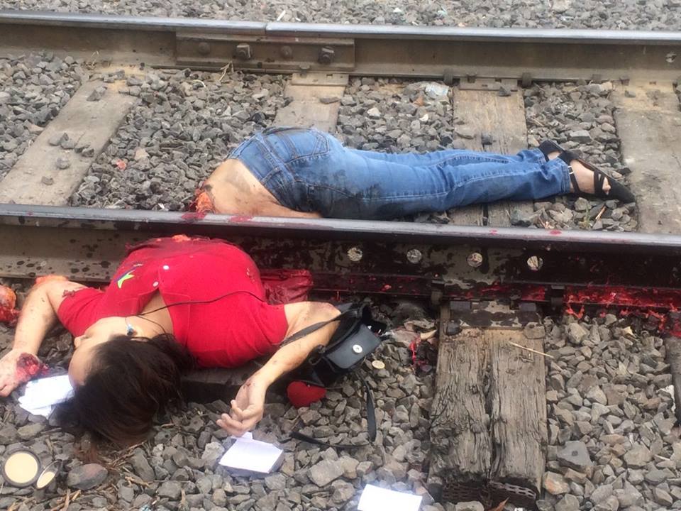 体を電車の車輪とレールで真っ二つにされた赤いシャツの女性